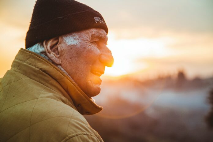 Photo by Matteo Vistocco man wearing brown jacket and knit cap