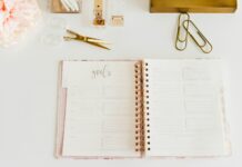 체중 감량을 위한 목표 설정법 scissors and two paper clips beside opened spiral notebook