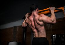 운동 후 근육통, 그냥 참아야 할까? topless man in black shorts holding orange bar