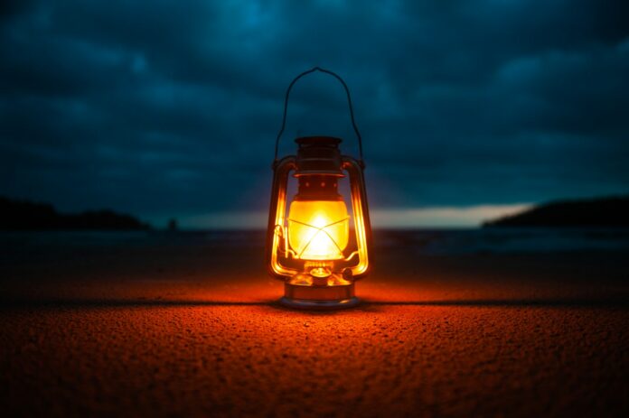 Photo by Vladimir Fedotov lighted kerosene lantern -