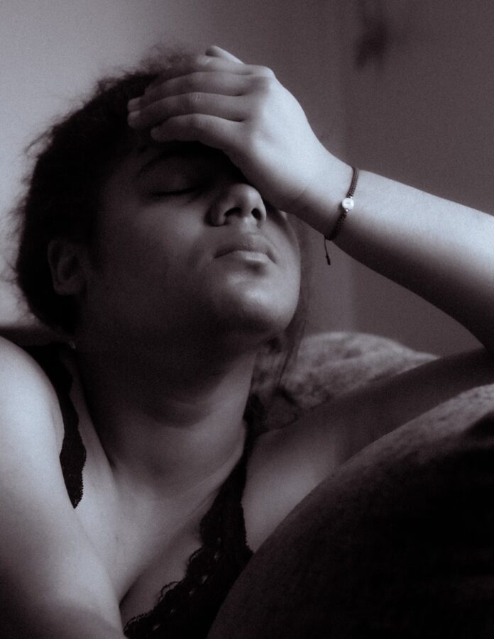 Photo by Earving Segura a black and white photo of a woman sitting on a couch