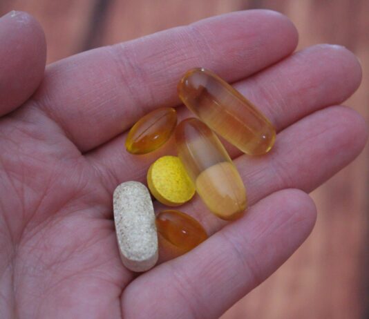 “나에게 맞는 영양 찾기, 보충제 활용의 새로운 트렌드” person holding medication pills