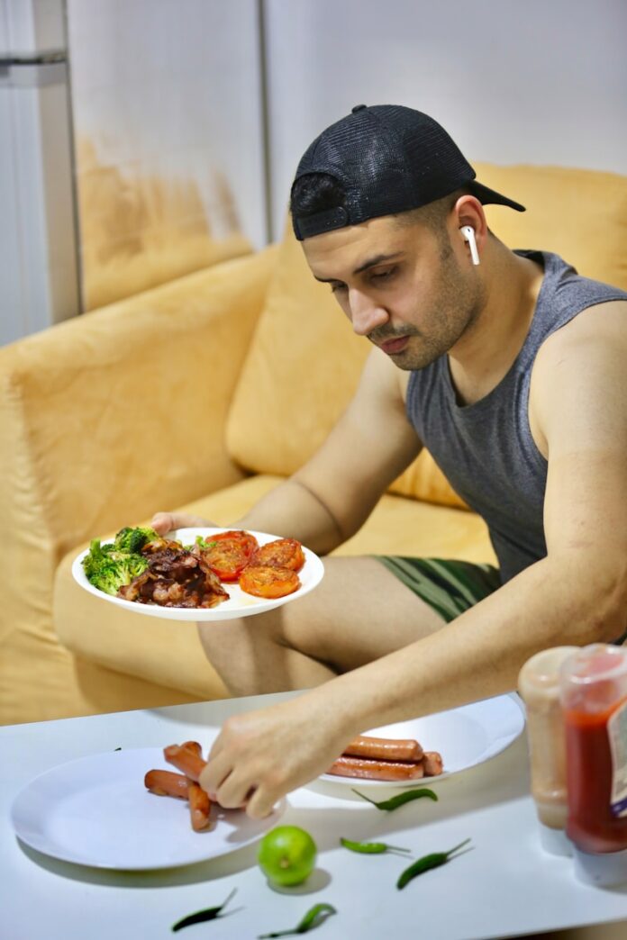 Photo by ANKUR MADAN a man sitting at a table with a plate of food