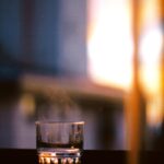 “마음이 더 건강해지는 아침 루틴, 꾸준한 실천이 삶을 바꾼다” a glass of water sitting on a window sill