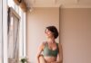 일상 속 필라테스, 내 몸을 위한 작은 변화의 시작 a woman in a green sports bra top and leggings holding a yoga mat