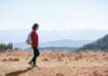 일상의 ‘걷기 습관’이 바꾸는 건강 트렌드…실천 루틴으로 만드는 방법 a man with a backpack walking across a dry grass covered field
