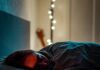 ‘저속노화’의 비밀을 풀다: 건강한 삶을 위한 실천 가이드 a person sleeping on a bed with some candles