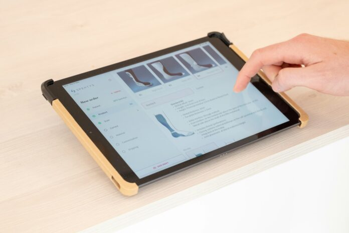 Photo by Tom Claes a person using a tablet on a table